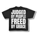 Black t-shirt with white text 'JUDGED BY PEOPLE FREED BY GRACE'