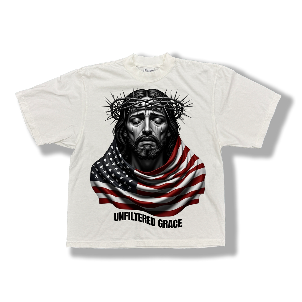 White t-shirt with a graphic of a Jesus wrapped with an American flag and black 'Unfiltered Grace' text 
