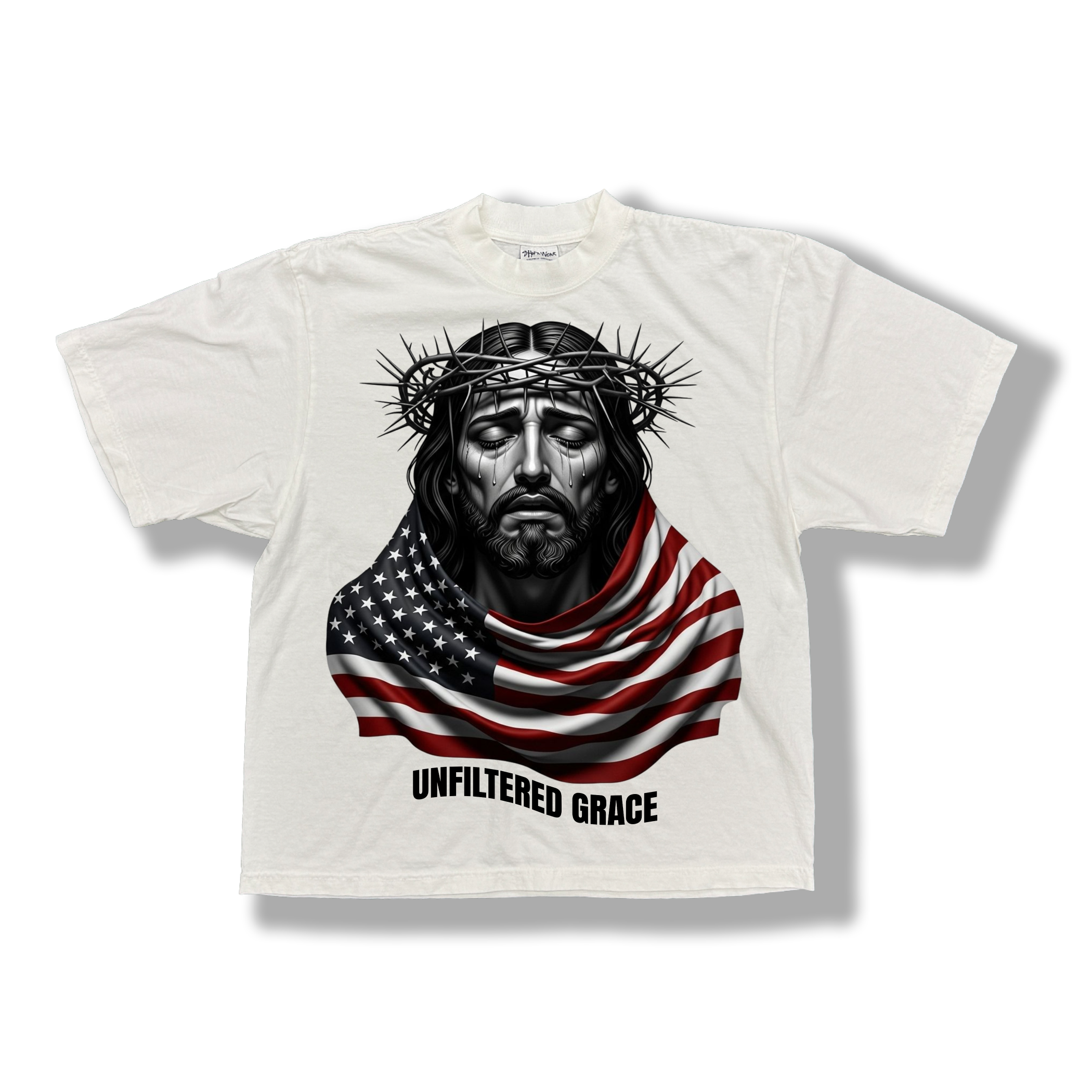 White t-shirt with a graphic of a Jesus wrapped with an American flag and black 'Unfiltered Grace' text 