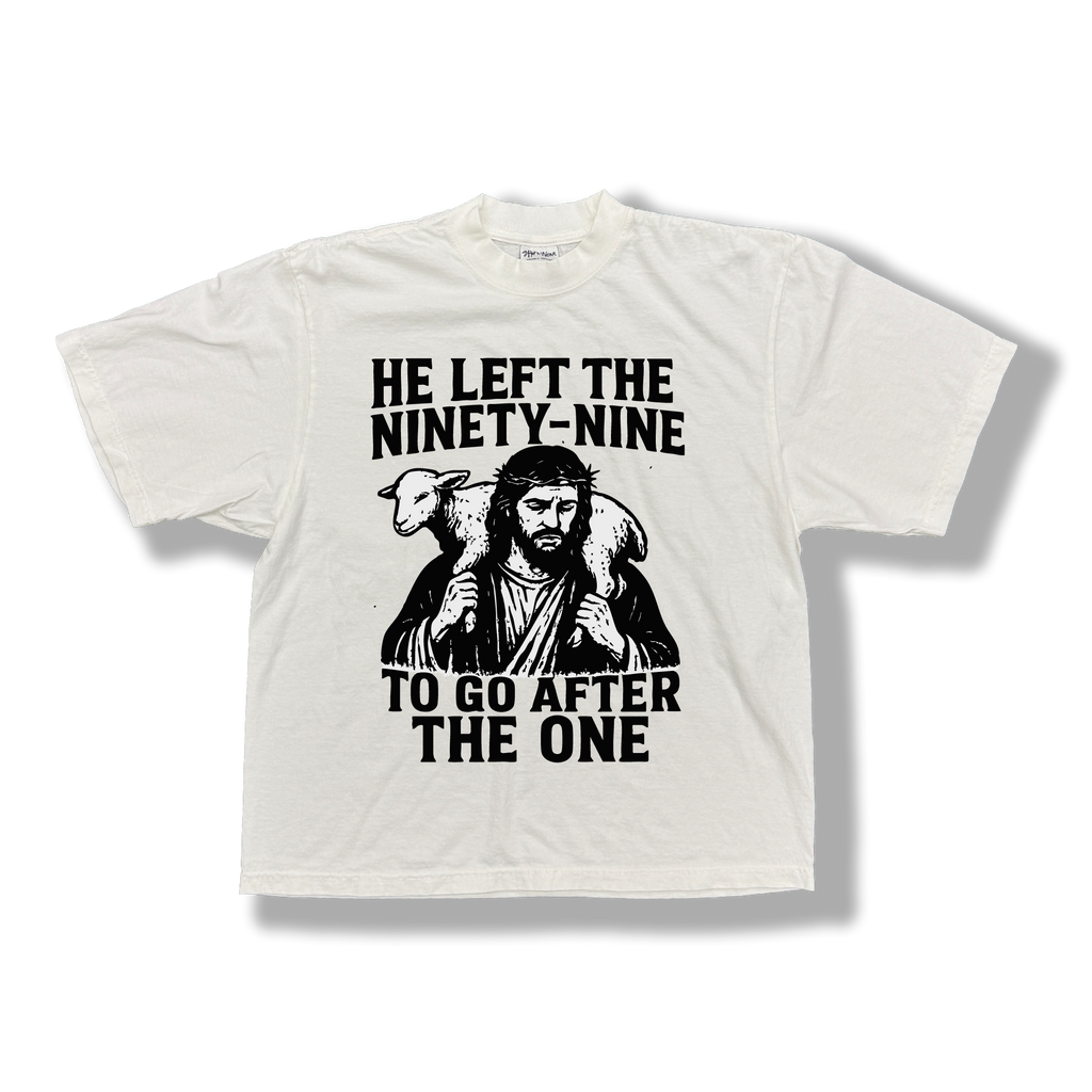 White t-shirt with graphic of Jesus holding a lamb and black 'HE LEFT THE NINETY-NINE TO GO AFTER THE ONE' text